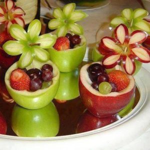 Green and red fruits carved into shapes