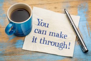 You can make it through! Handwriting on a napkin with a cup of espresso coffee.