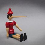 the puppet, Pinocchio, with a long nose from lying