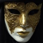 a face in white pain emerging from darkness with an exotic gold mask - hiding - Imposter Syndrome