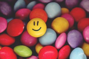 colorful candies. the yellow one wears a smile. Image by Tante Tati.