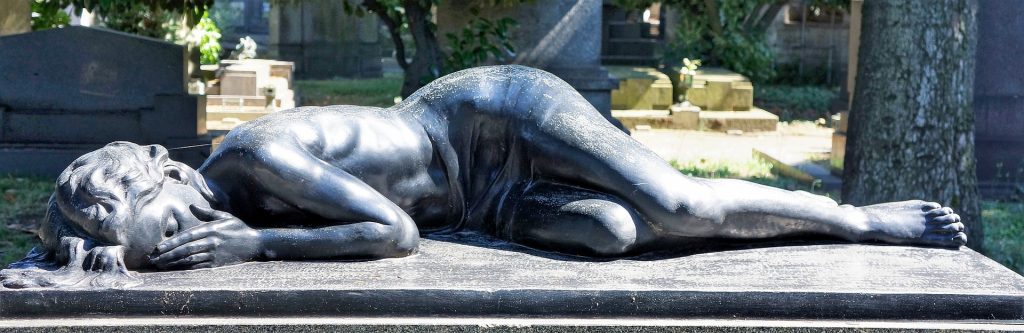 A photo of a sculpture of a woman lying on a gravestone in loss and grief - by Richard Mcall - for #vss365