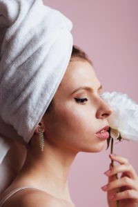 white woman in white towel turban, with white flower blossom at her cheek by Victoriia Malysh for poem with a surprise ending