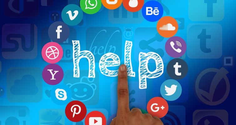 A finger points at a circle of social media internet icons and the word "help" in the middle of them. Looking for logic