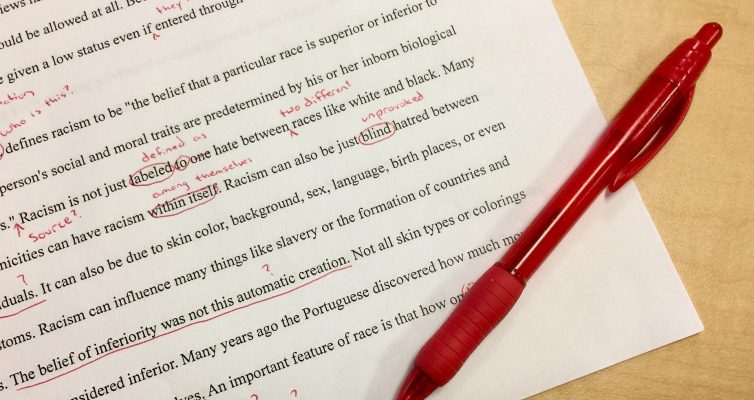 typed paper with red marking and a red pen - for Editing Anything