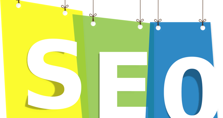 SEO signifying Search Engine Optimization is written on yellow, green, and blue tags