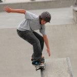 Young Boy in protective helmet Skateboarding